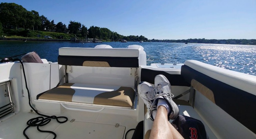 My Legs Getting to Sun While my Kids and GKs Take a Turn at the Helm.